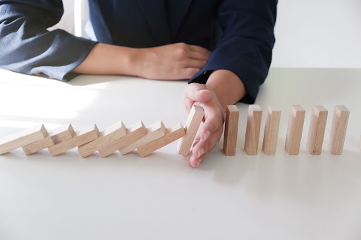 hand stopping wooden dominoes