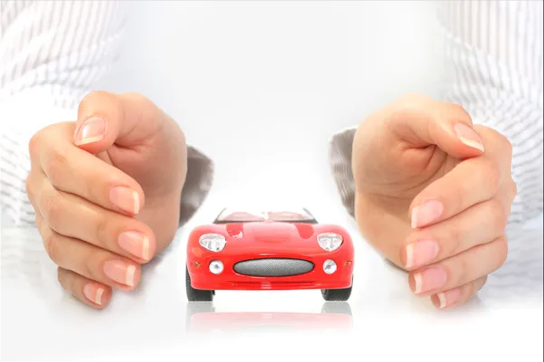 red toy car in between a person's hand